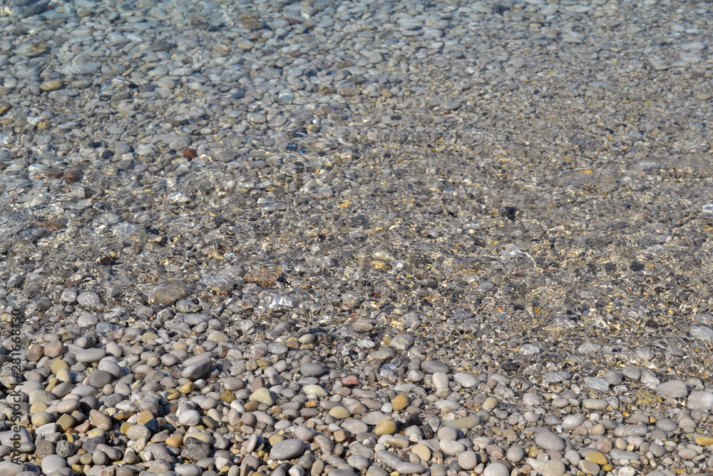 Abstract beach background texture with pebbles, sands and sea water in bodrum turkey Abstract beach background texture with pebbles, sands and sea water in bodrum turkey
