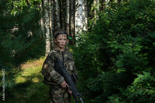 Boy playing in lasertag shooting game, boy with a gun, war simulation.