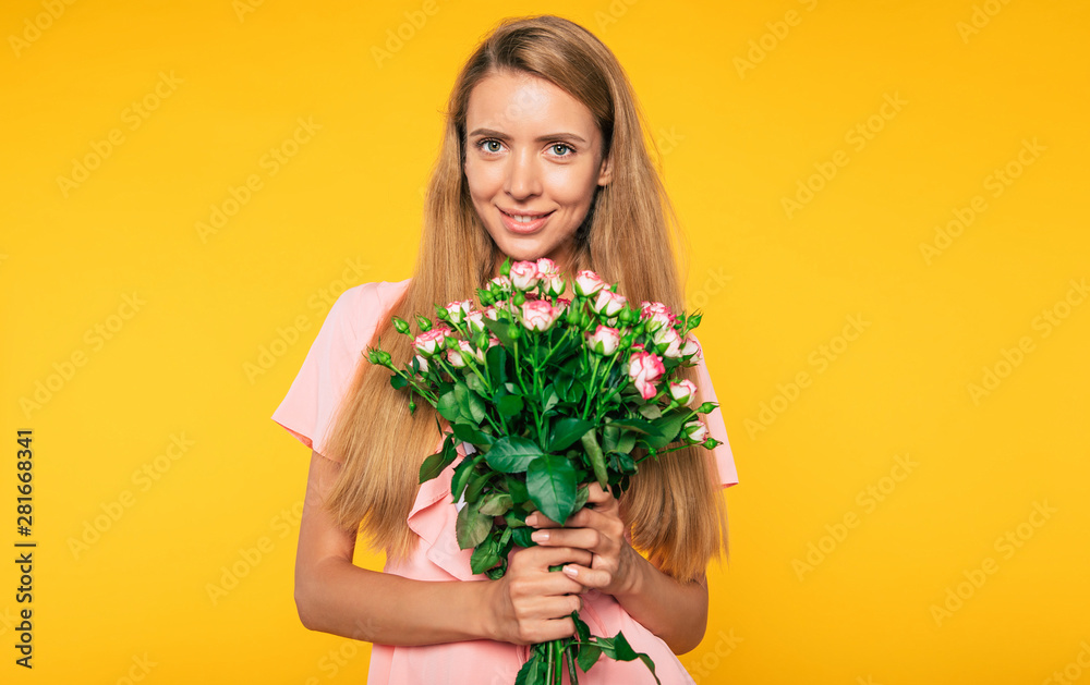 Lovely present. Portrait of tender attractive blonde woman with big bouquet of roses. Holidays and gifts concept. Women's day. St. Valentine's day Lovely present. Portrait of tender attractive blonde woman with big bouquet of roses. Holidays and gifts concept. Women's day. St. Valentine's day