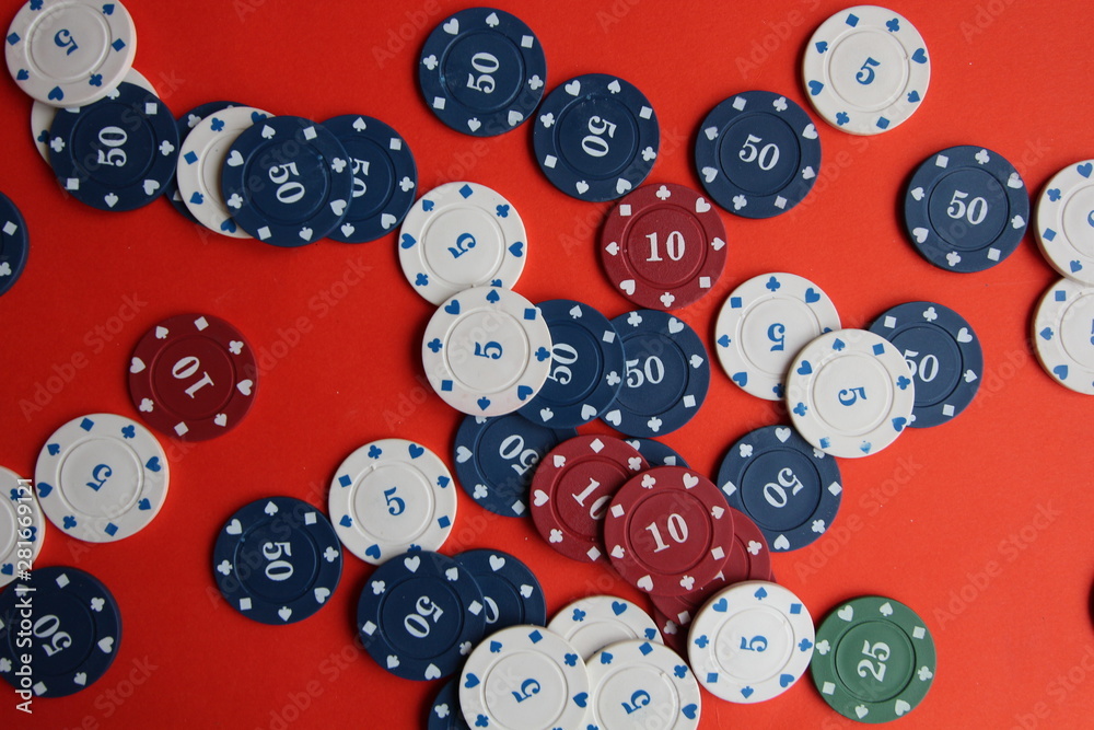 poker cards, pocker chips, money, pocker dice on red background. gambling, board games