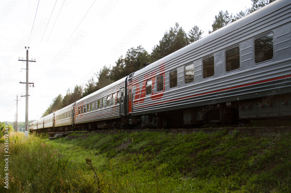 Fototapeta premium Red-gray passenger long-distance train close-up. Russian Railways.