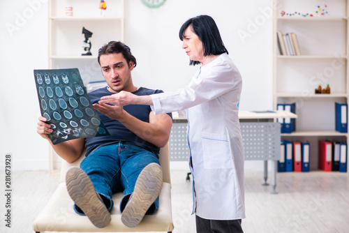 Young male patient visiting aged female doctor