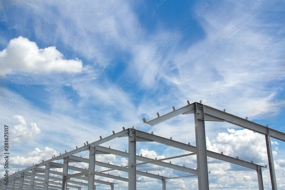 Metalwork against the blue sky on a clear sunny day. The construction of prefabricated buildings and structures for agriculture.