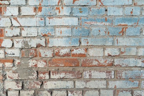 Brickwork scratched on a wall dark blue with red. White paint. Background from an old brick wall.