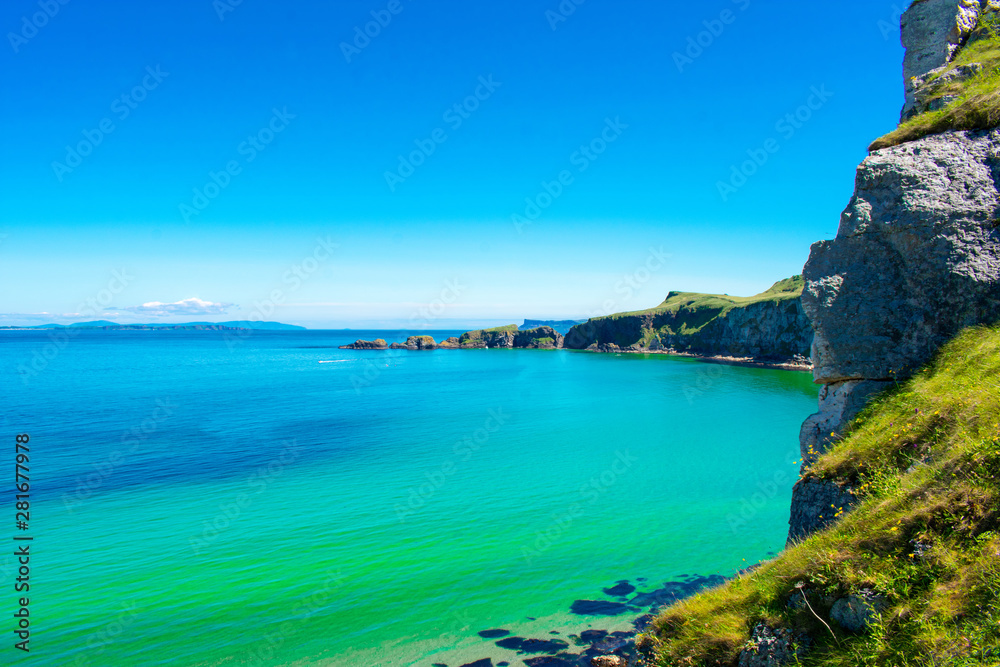 Carrick a Rede Rope Bridge in Ballintoy, Northern Ireland. Beautiful Landscape on Coast of Atlantic Ocean, Clear blue and green water 
