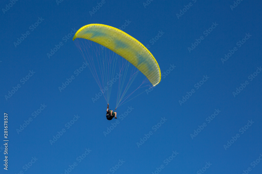 paraglider flying in the blue sky among the white clouds. Paragliding paraglider flying in the blue sky among the white clouds. Paragliding