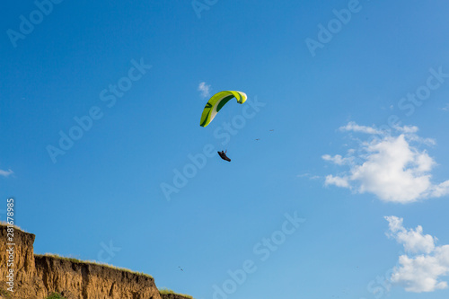 paraglider flying in the blue sky. Paragliding