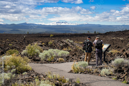 Hikers observing sign in Lava Lands, Oregon