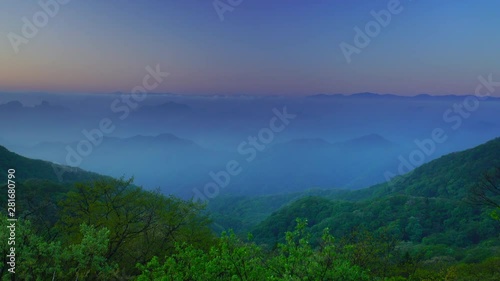 Zoom out view of mountain range at sunrise photo