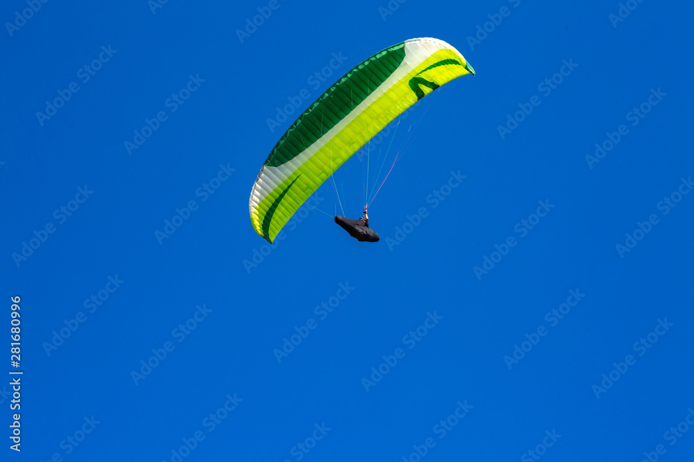 paraglider flying in the blue sky. Paragliding paraglider flying in the blue sky. Paragliding