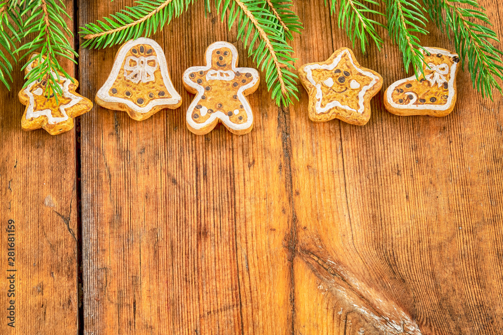 Christmas gingerbread cookies and twigs of Christmas tree on a wooden table Christmas gingerbread cookies and twigs of Christmas tree on a wooden table