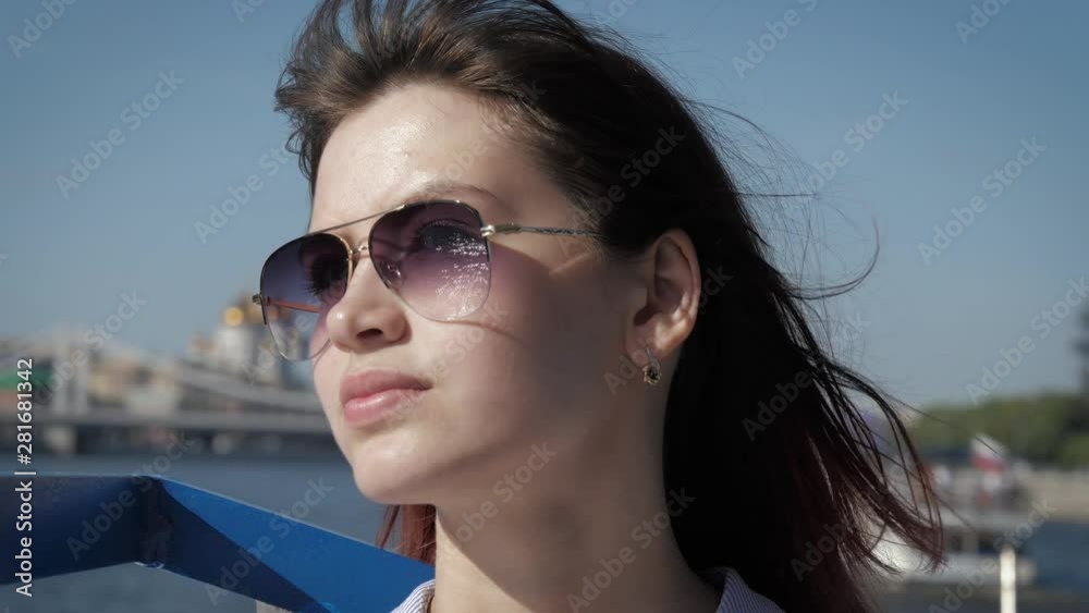 Portrait Of Stylish Lovely Woman With Sunglasses And Waving Hair In The Wind Portrait Of Stylish Lovely Woman With Sunglasses And Waving Hair In The Wind