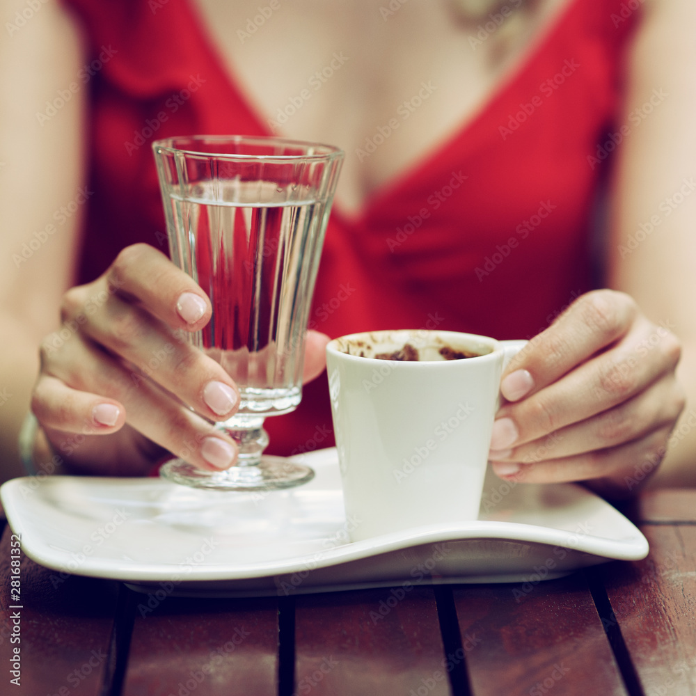 Close up hands of woman with traditional turkish coffee in street coffee.