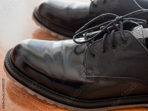 closeup of man black glossy formal shoes, profile view with shoelaces