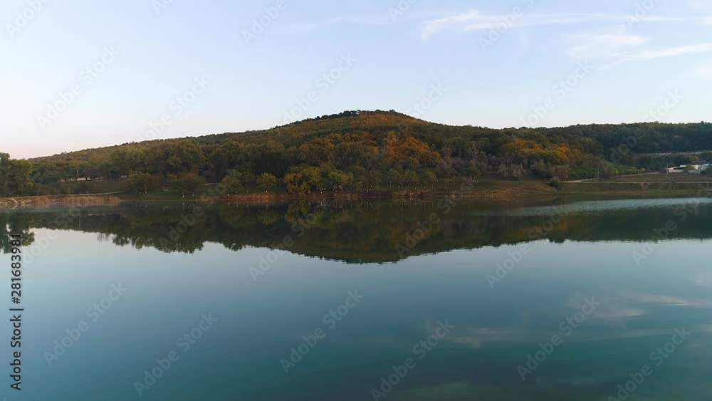 A river reflecting an image of the trees at it's coast. A river reflecting an image of the trees at it's coast.