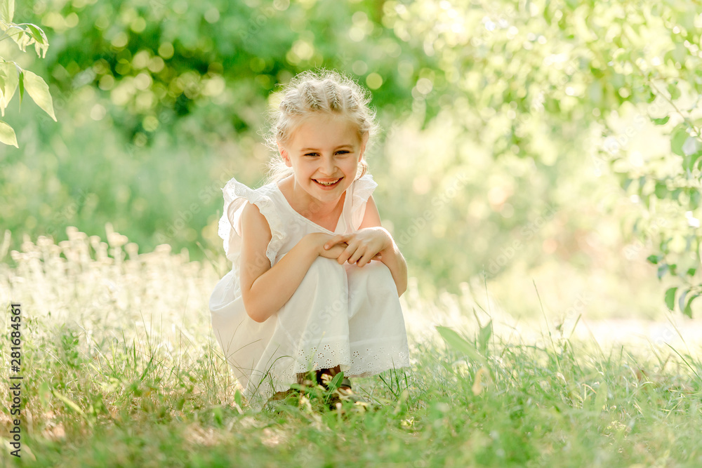 Preschool girl sitting on the grass Preschool girl sitting on the grass