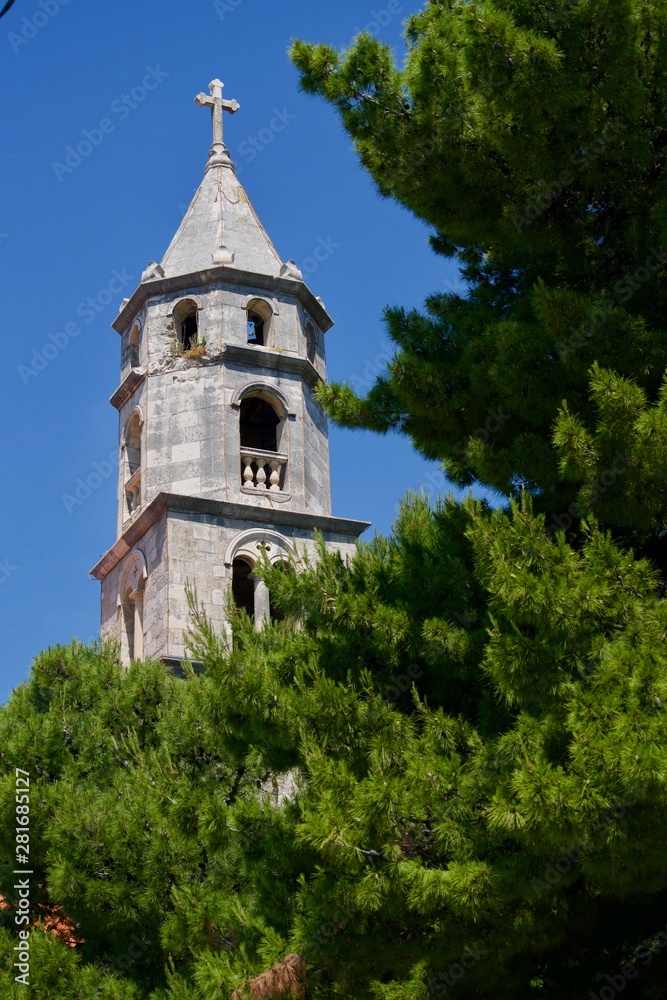 Steeple behind pines