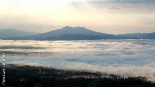 Mount Shari above sea of clouds at sunset,  Hokkaido,  Japan photo