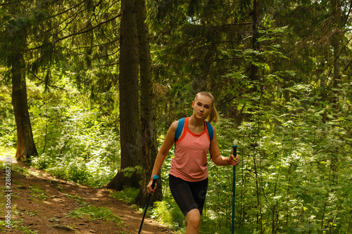 young woman trekking in a mountain forest
