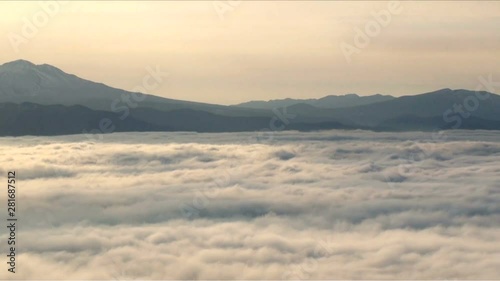 Mount Shari above sea of clouds at sunset,  Hokkaido,  Japan photo