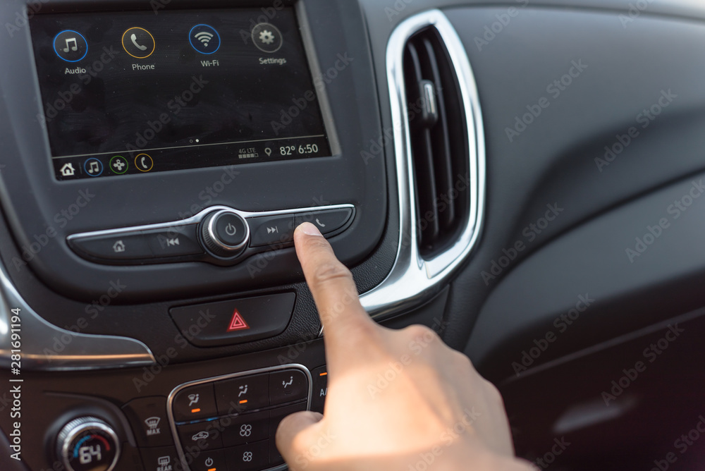 Male hand press the Call button on modern car dashboard