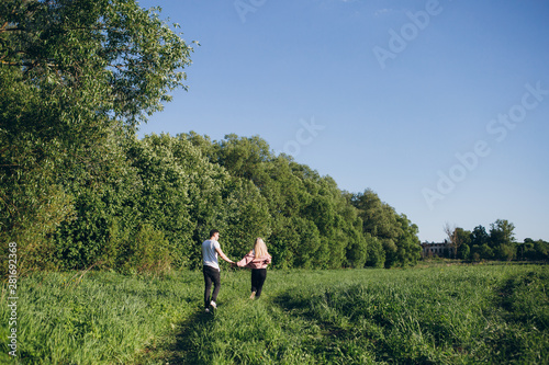 Couple guy and girl running hand in hand on the road in nature © irina_timokhina