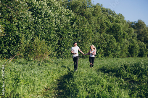 Couple guy and girl running hand in hand on the road in nature © irina_timokhina