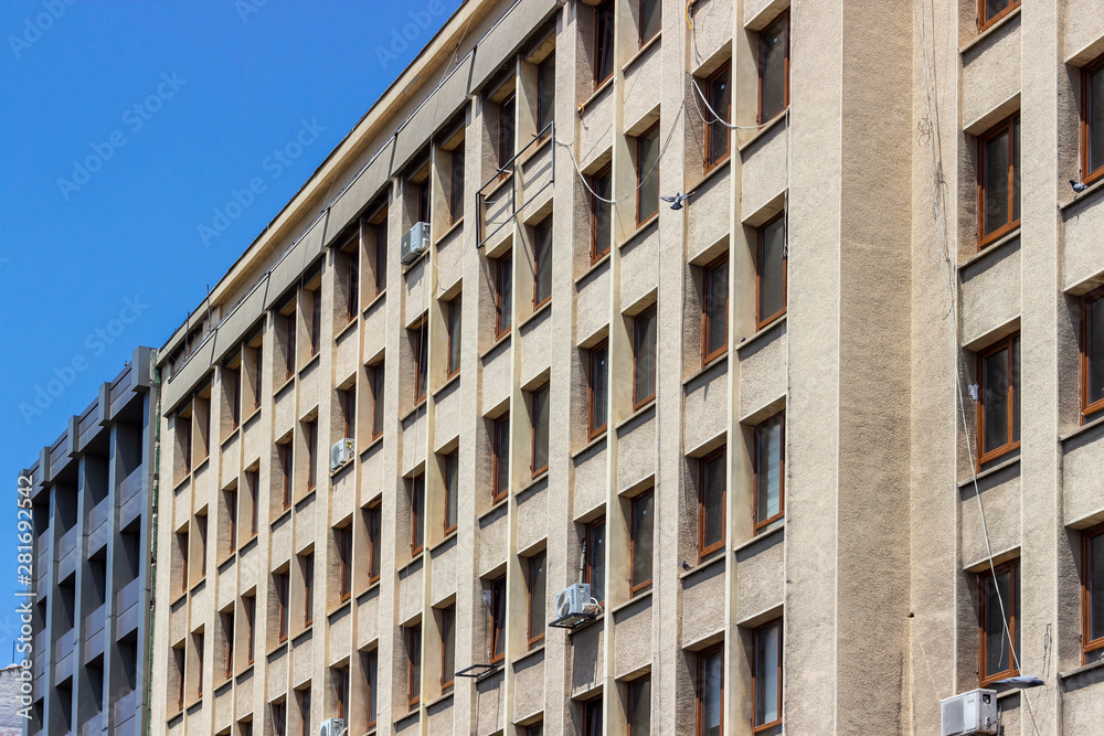 Perspective shoot of old turkish concrete municipality building facade with open yellow tones