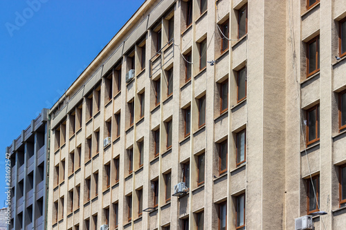 Perspective shoot of old turkish concrete municipality building facade with open yellow tones