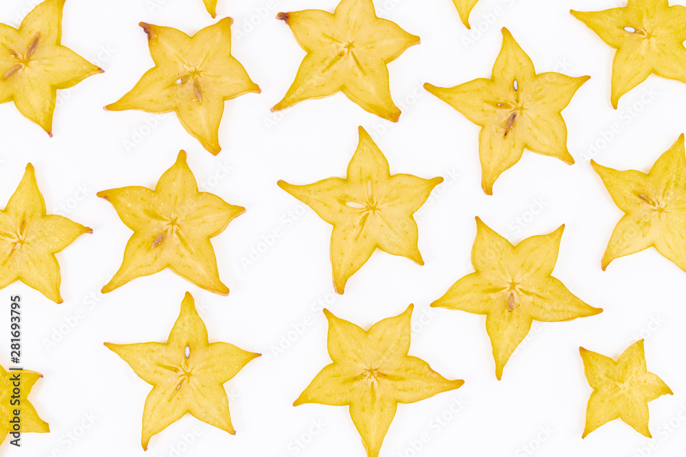 Ripe and exotic slices of star fruit scattered on a white background - Averrhoa carambola - Ripe Carambola Ripe and exotic slices of star fruit scattered on a white background - Averrhoa carambola - Ripe Carambola