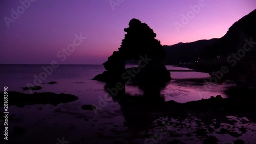 Window rock in sea at sunrise photo