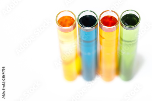 Test tubes filled with various water testing liquids on white background