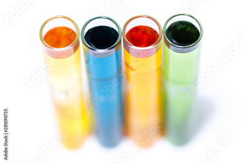 Test tubes filled with various water testing liquids on white background