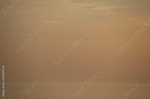 lonley fishermen boat silhouette against orange sunrise on Lake Malawi, the sun glitter on the Lake, South-East-Africa