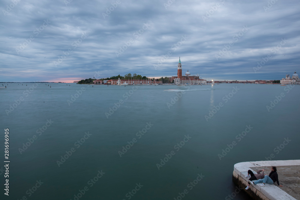 Venice in the blue hour,beautiful dusk in Venice with ships,gondolas and tourists enjoying the atmosphere.