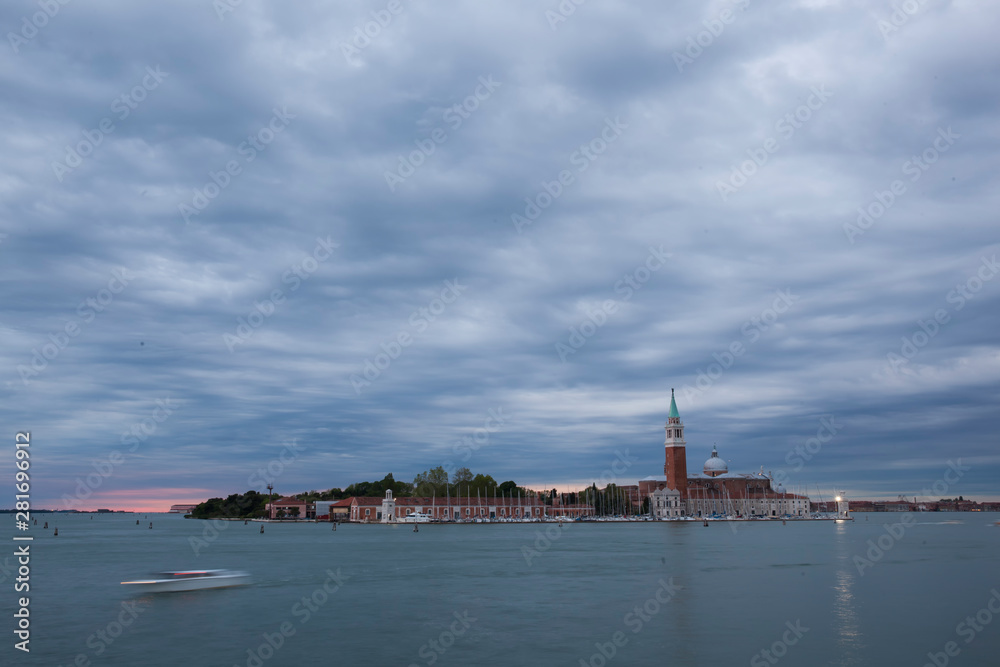 Venice in the blue hour,beautiful dusk in Venice with ships,gondolas and tourists enjoying the atmosphere.