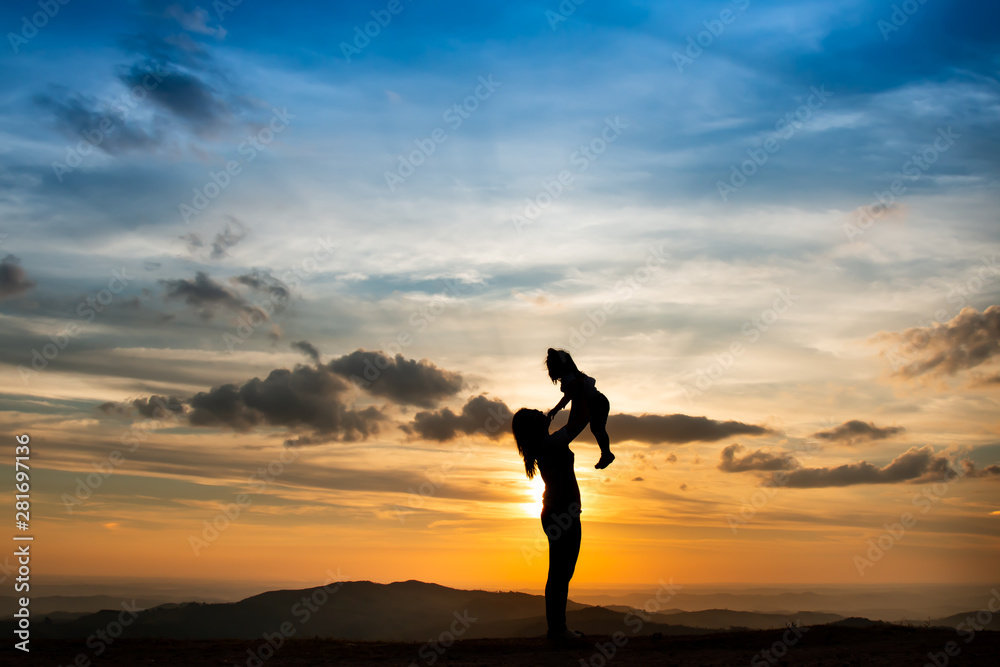 silhouette of woman on top of mountain with your daughter in sunset