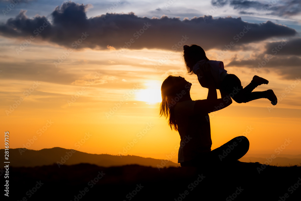 silhouette of woman on top of mountain with your daughter in sunset silhouette of woman on top of mountain with your daughter in sunset