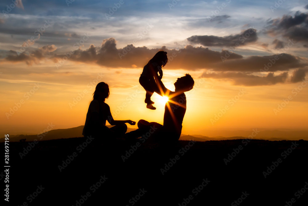 silhouette of family at sunset