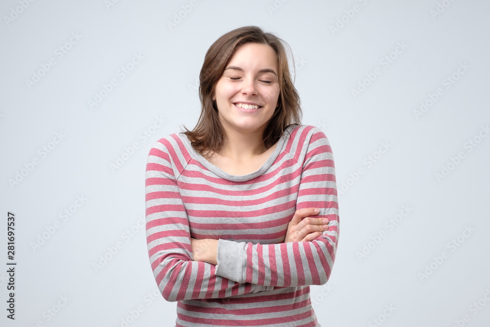 Happy cheerful young woman looking at camera with joyful and charming smile. Positive facial human emotion. Studio shot. Happy cheerful young woman looking at camera with joyful and charming smile. Positive facial human emotion. Studio shot.