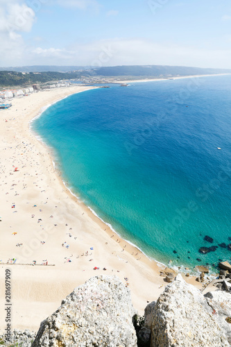 Fototapeta Naklejka Na Ścianę i Meble -  Nazare, Leiria, Portugal - July 01, 2019: View of Nazare Beach, from the viewpoint of Suberco, in the Leiria District, in Portugal.
