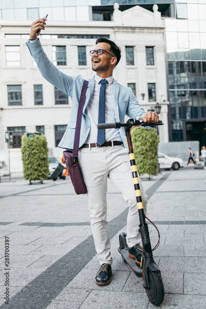 Young modern man using and driving electric scooter on city street. Modern and ecological transportation concept. Young modern man using and driving electric scooter on city street. Modern and ecological transportation concept.