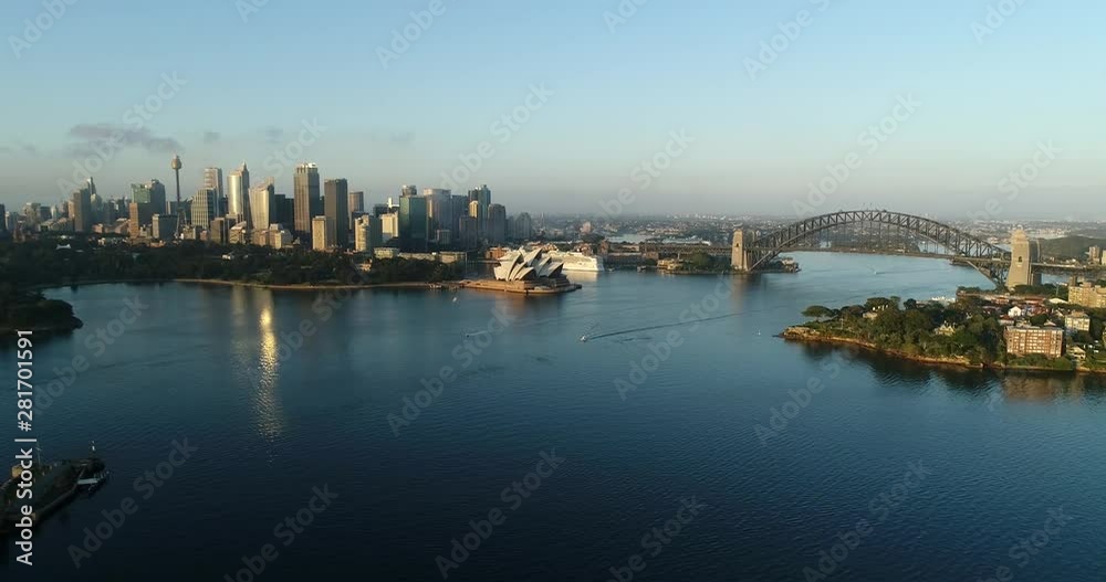 Blue waters of Sydney Harbour in view of major city CBD landmarks, Fort Denison and waterfronts of shores with residential buildings. Blue waters of Sydney Harbour in view of major city CBD landmarks, Fort Denison and waterfronts of shores with residential buildings.