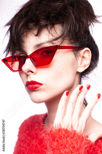 Fototapeta young woman in red sunglasses, red nails, red lipstick