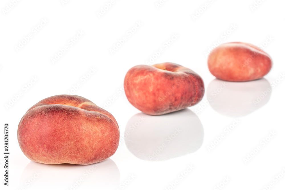 Group of three whole fresh red peach prunus persica platycarpa placed diagonally in line isolated on white background Group of three whole fresh red peach prunus persica platycarpa placed diagonally in line isolated on white background