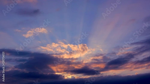 Sunlight piercing clouds at summer dawn photo