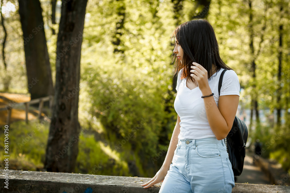Portrait of stylish young woman with backpack, sunny summer fashion trend, backlight. Copy space Portrait of stylish young woman with backpack, sunny summer fashion trend, backlight. Copy space