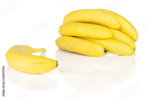 Lot of whole ripe yellow banana one is aside isolated on white background