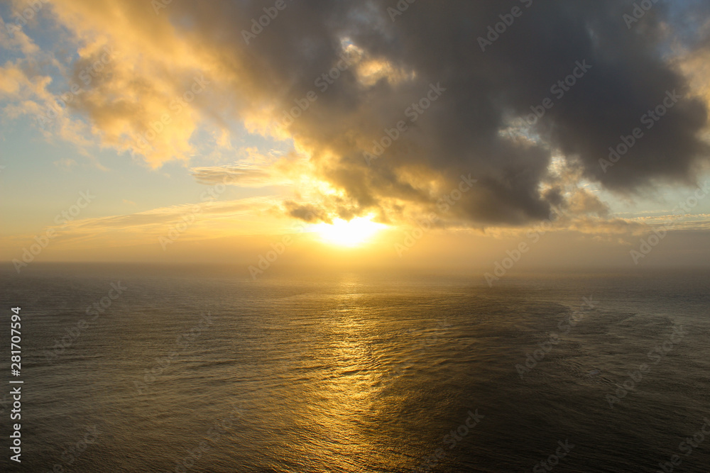 Sunset at Cape Reinga, New Zealand where currents collide. 