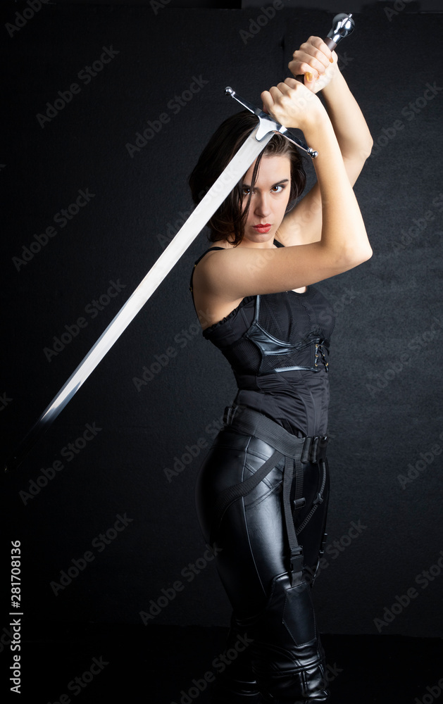 Woman in urban fantasy costumes holding weapons Woman in urban fantasy costumes holding weapons